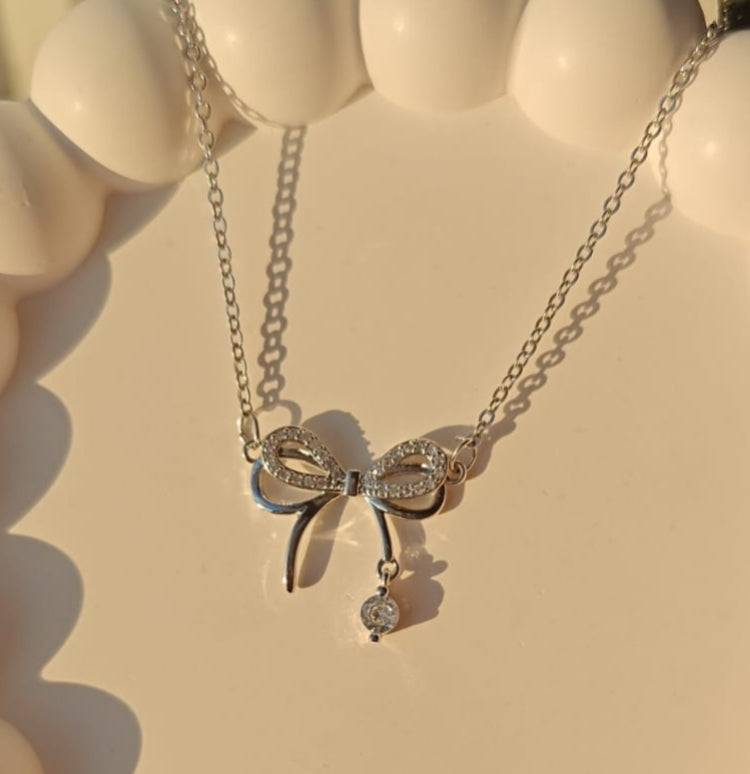 Silver plated infinity bow drop pendant