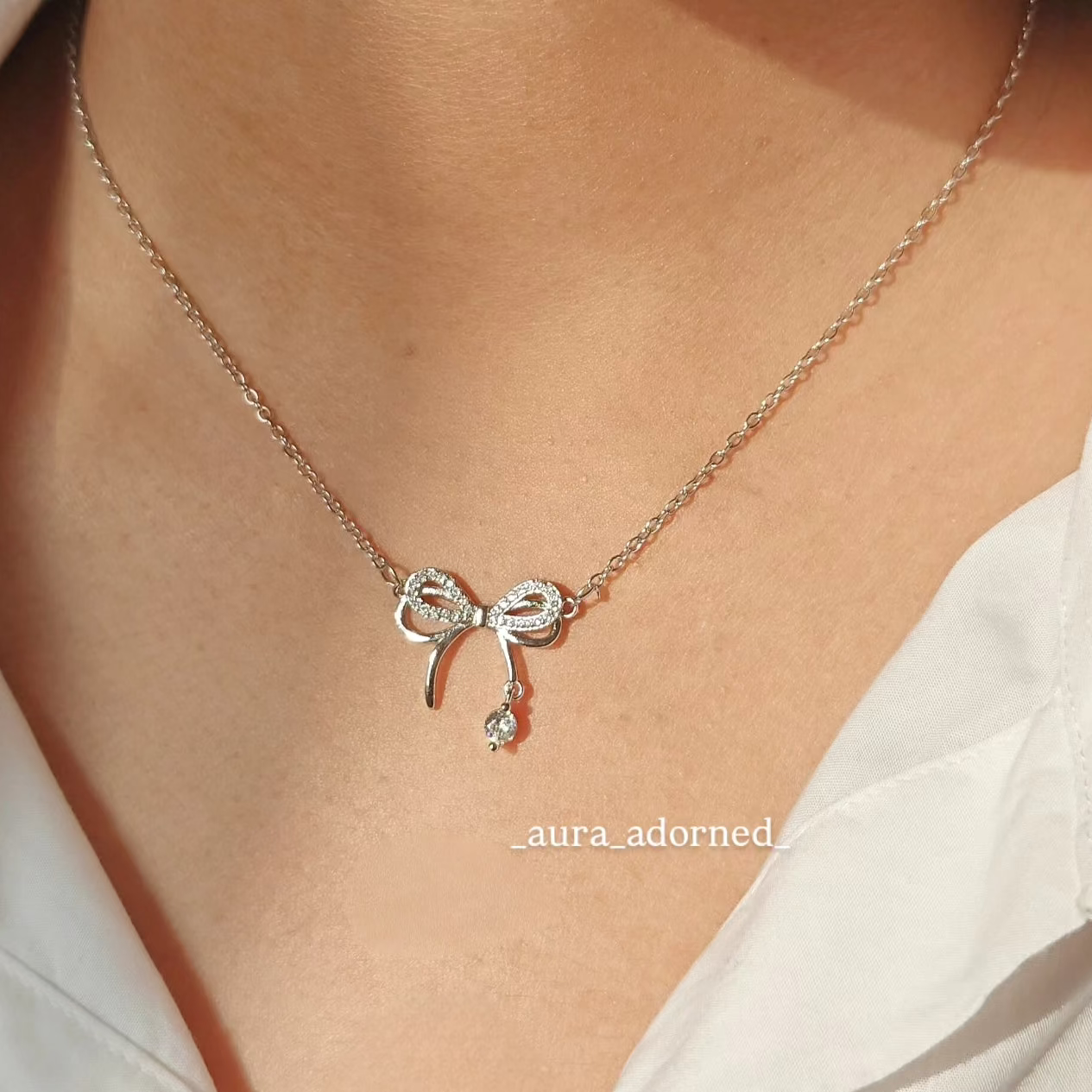 Silver plated infinity bow drop pendant